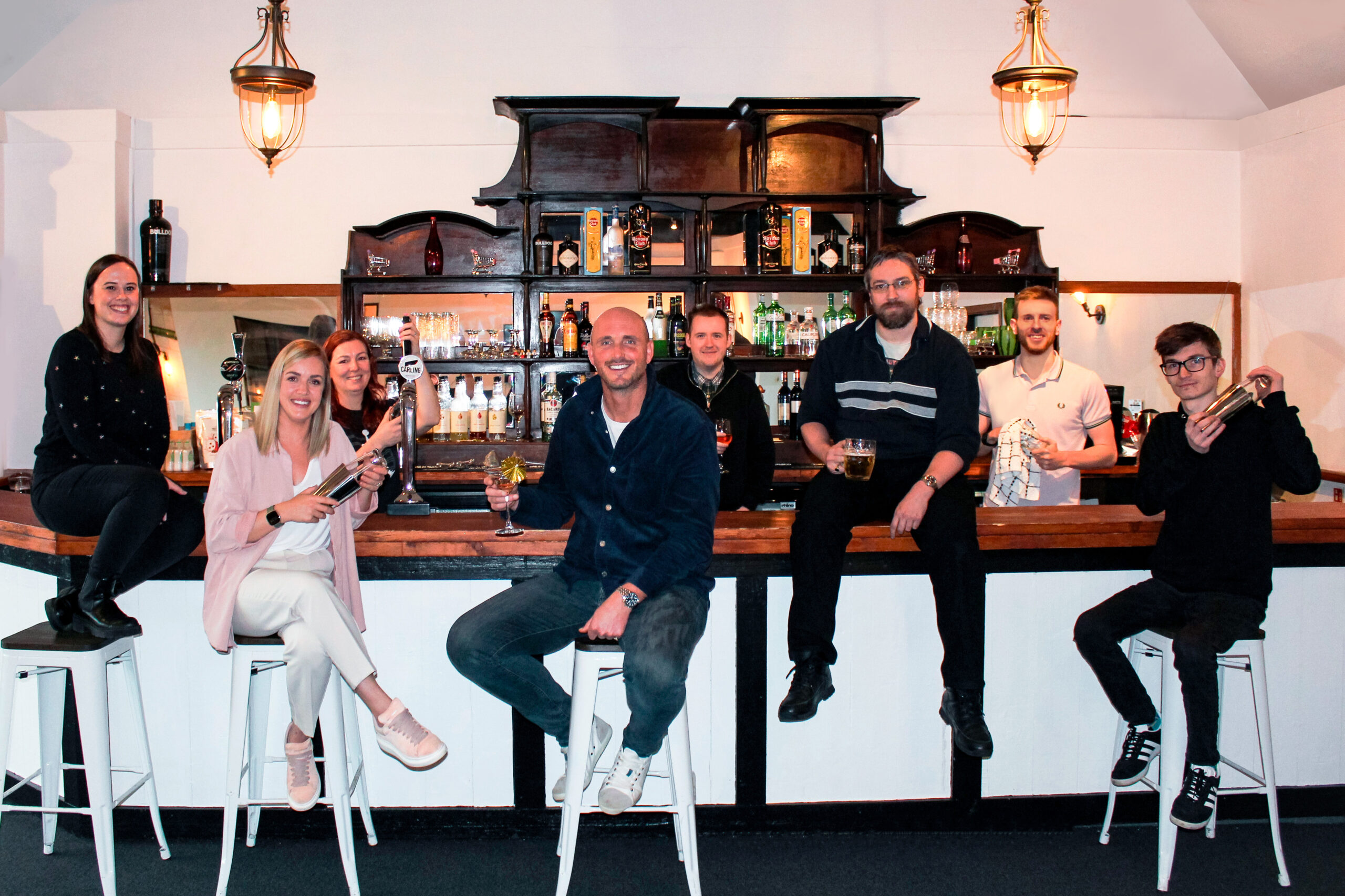 The team in the office stood behind the bar.